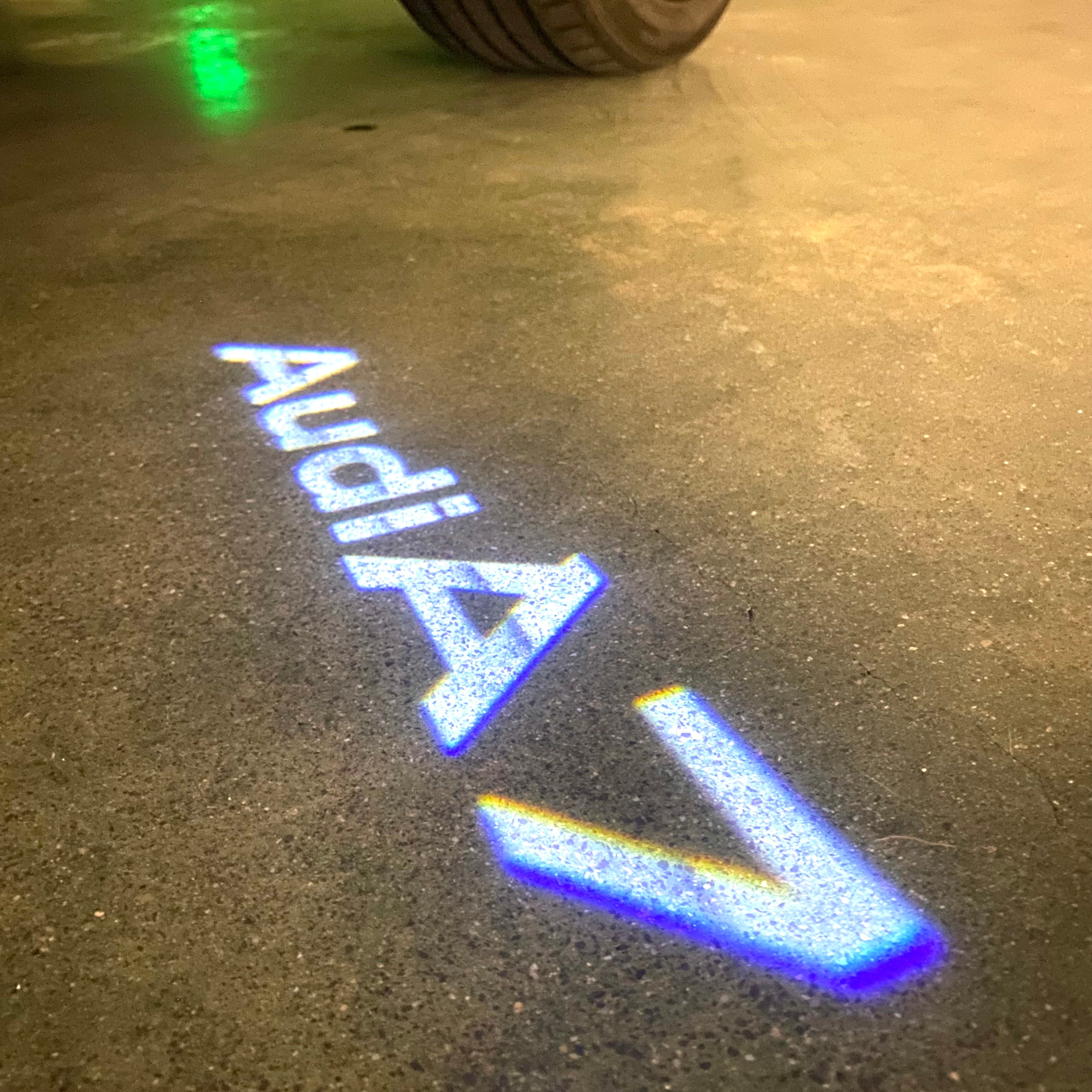 LUCES DE PROYECTOR LOGO AUDI No 120 (cantidad 1 = 2 películas con logotipo / 2 luces de puerta)