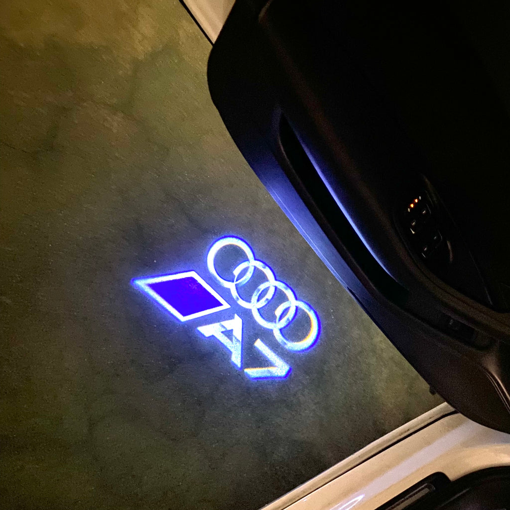 LUCES DE PROYECTOR LOGO AUDI No 120 (cantidad 1 = 2 películas con logotipo / 2 luces de puerta)
