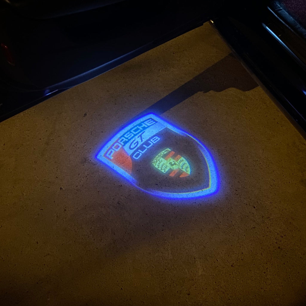 LUCI PROIETTORI LOGO ORIGINALI PORSCHE Nr.03 (quantità 1 = 2 Logo Film / 2 luci porta)