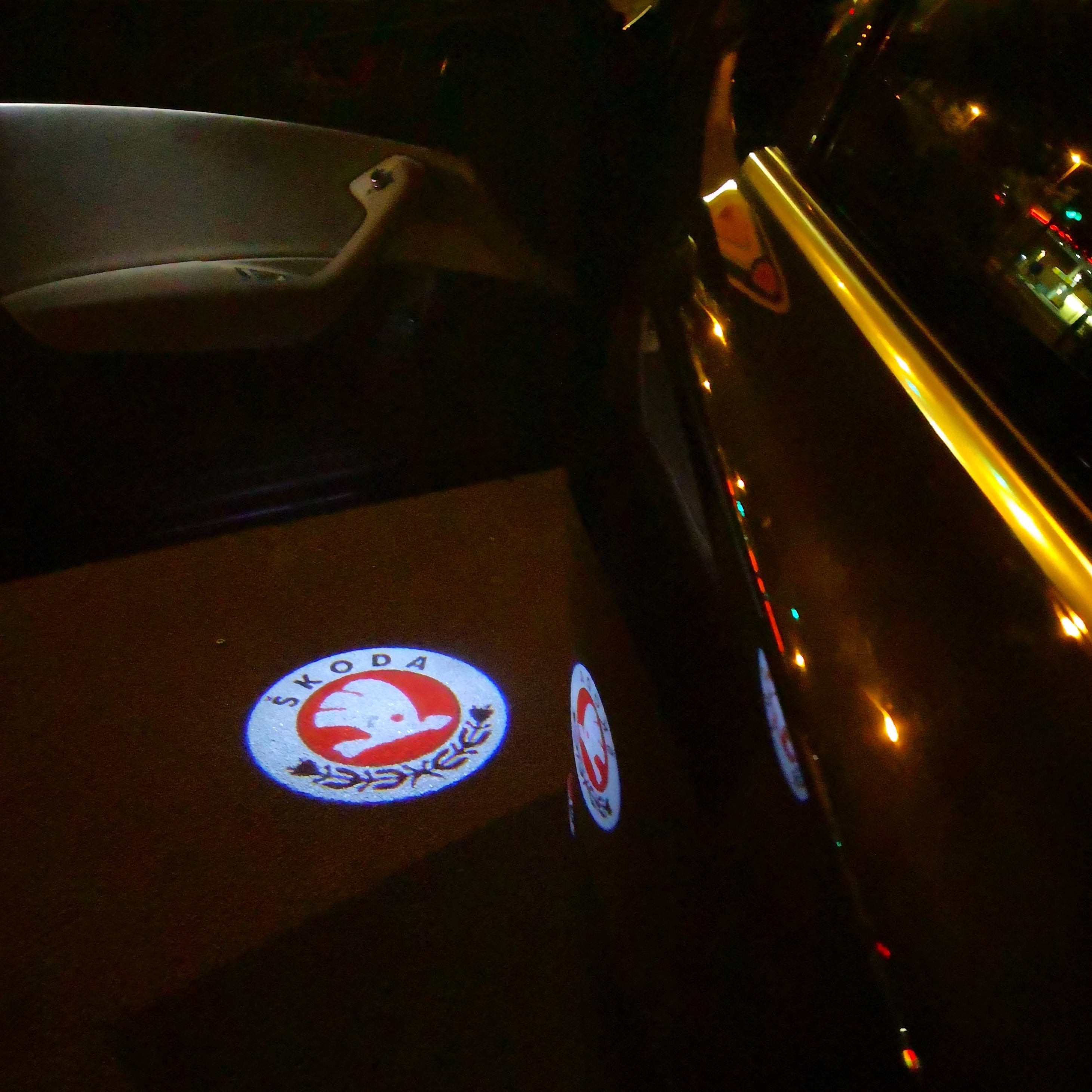 SKODA ORIGINAL LOGO PROJECTOT LIGHTS Nr.12(quantity  1 =  2 Logo Film /  2 door lights)