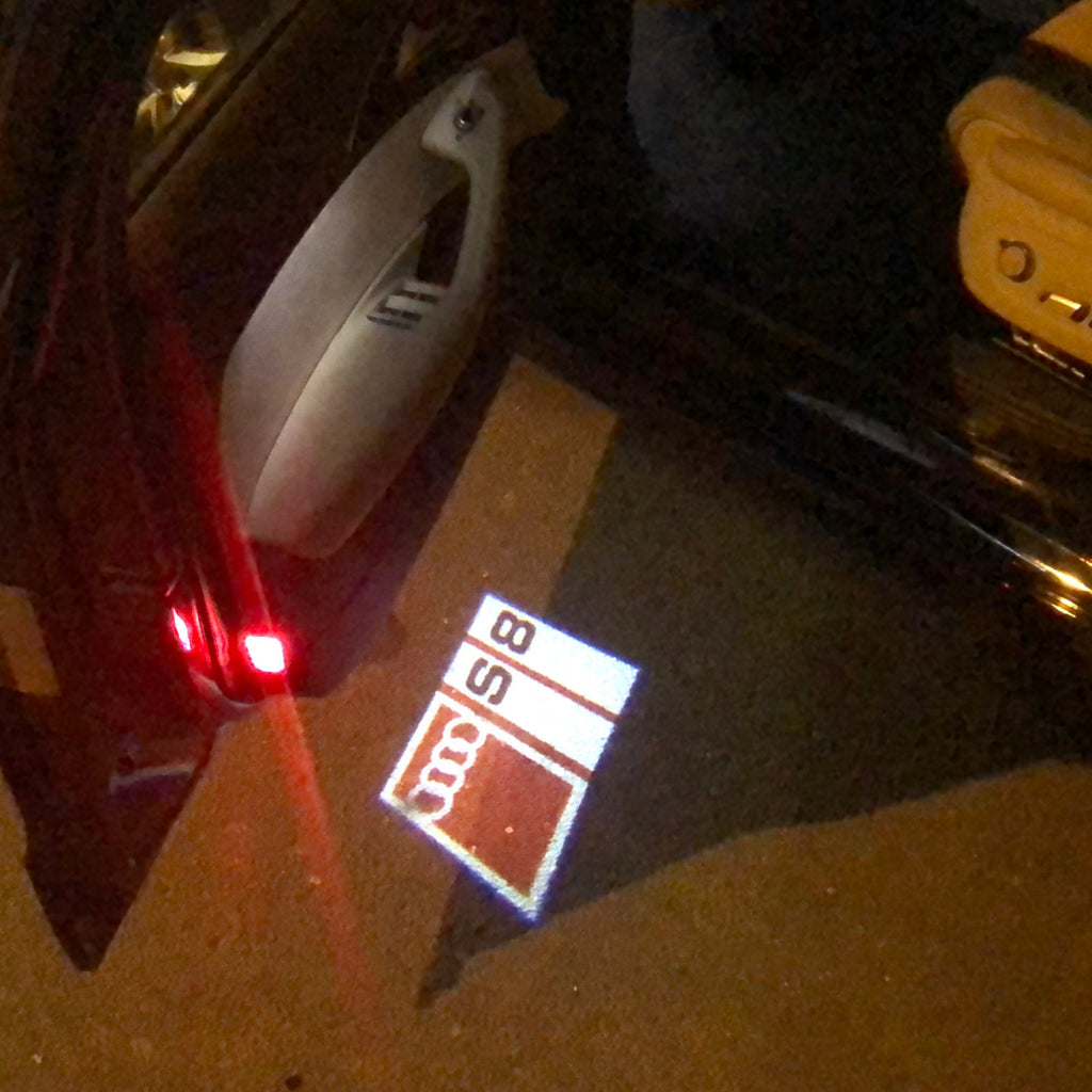 LUCI PROIETTORI LOGO AUDI Nr.149 (quantità 1 = 2 Pellicole Logo / 2 luci porta)